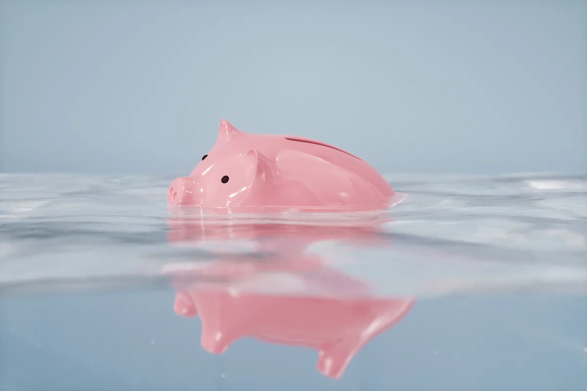 A sinking piggy bank represents the value that is at stake when conducting distressed asset investigations.