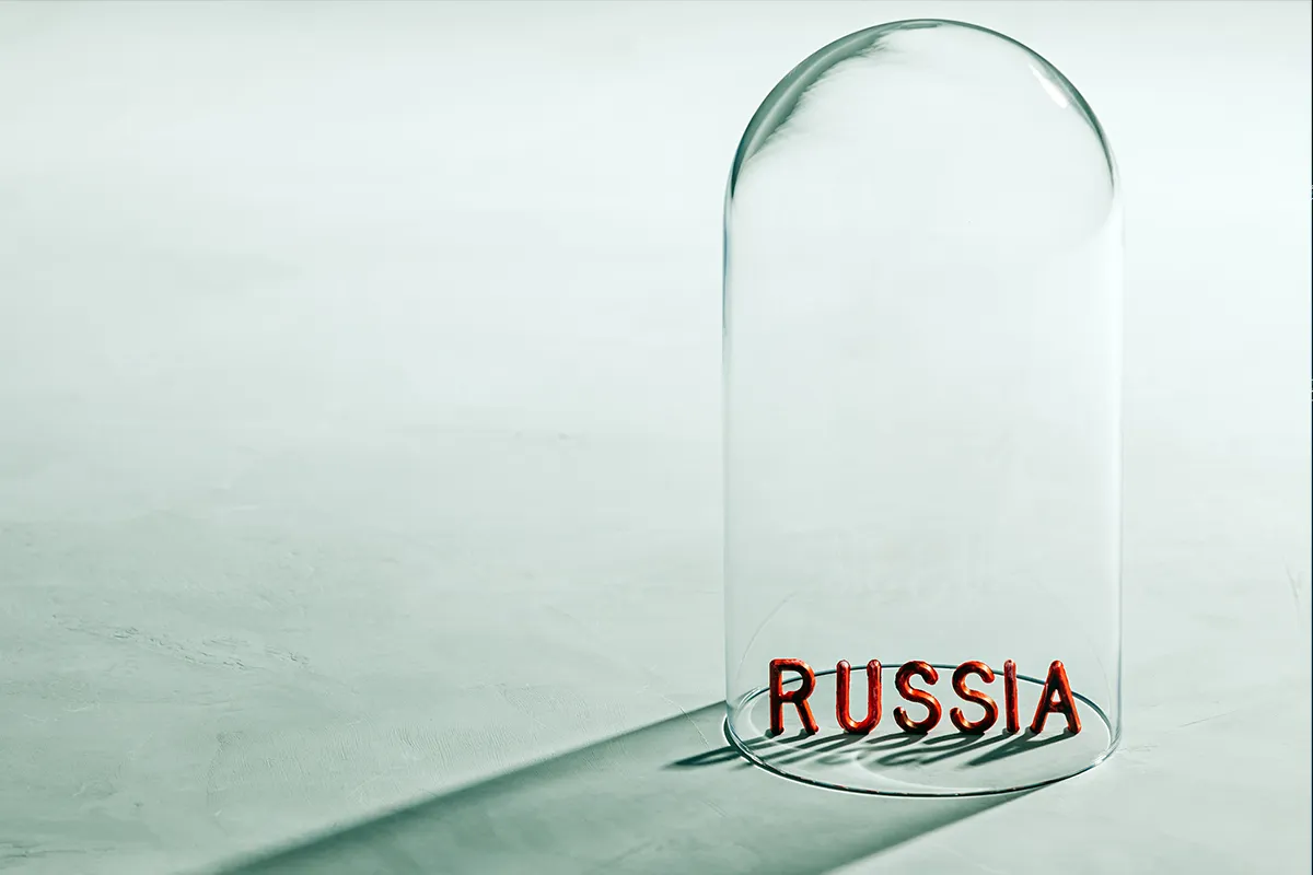 Russia written in red letters under a glass cover, representing a global isolation and sanctions on Russia.