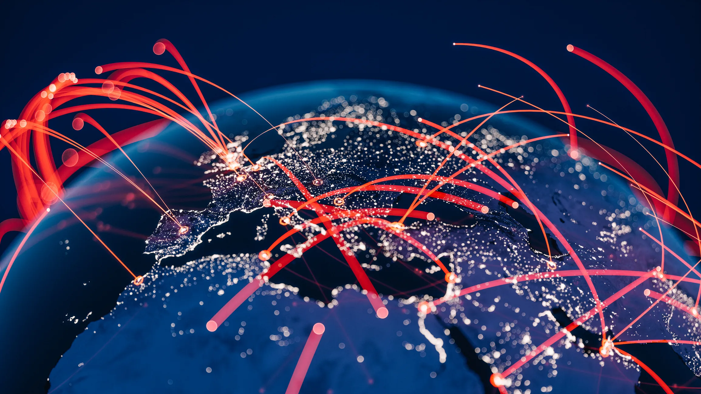 View of blue globe at night with connection lines between cities, representing global supply chains.