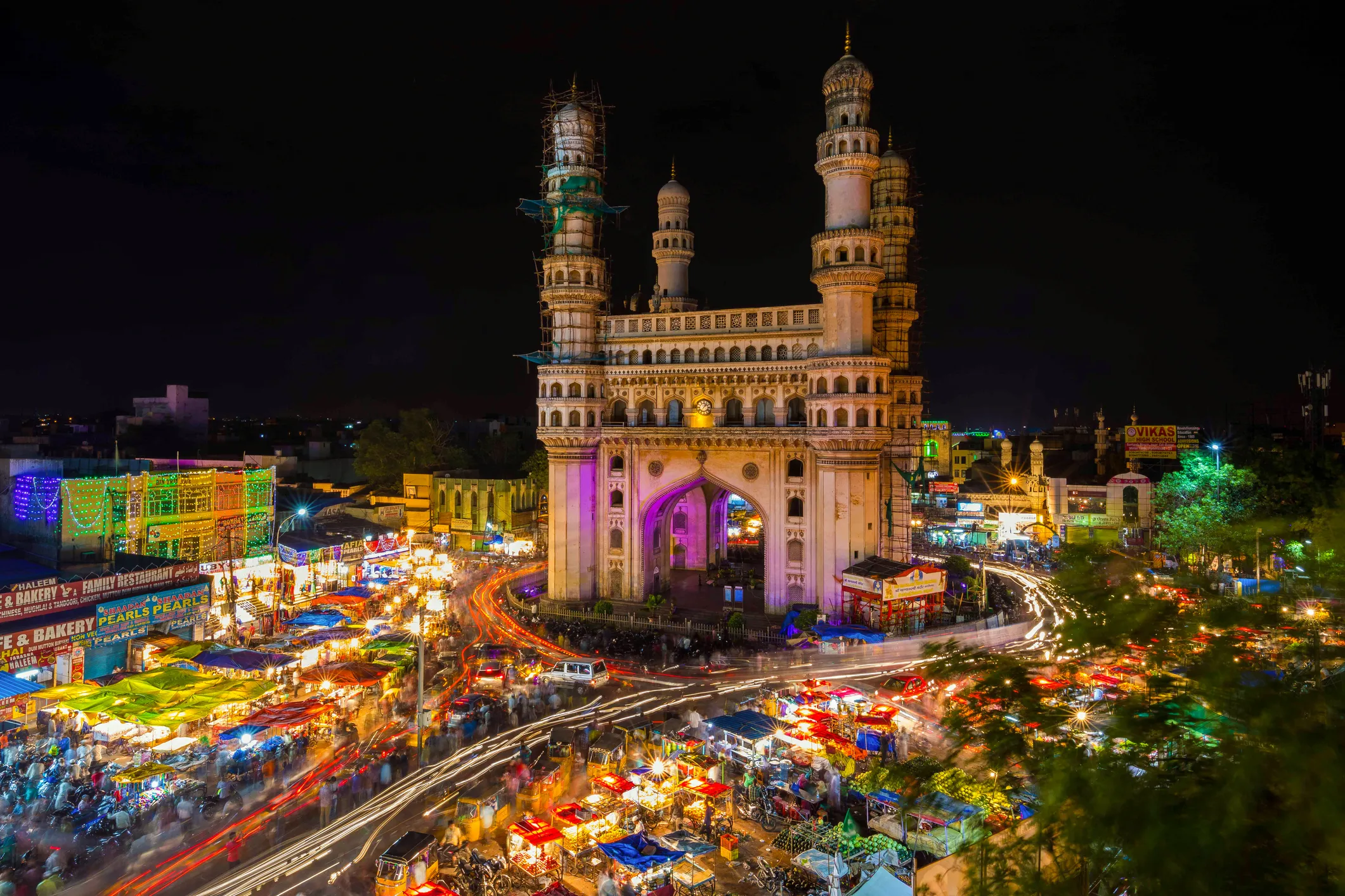 Long Exposure Shot of Traffic moving around Charminar in India at night.