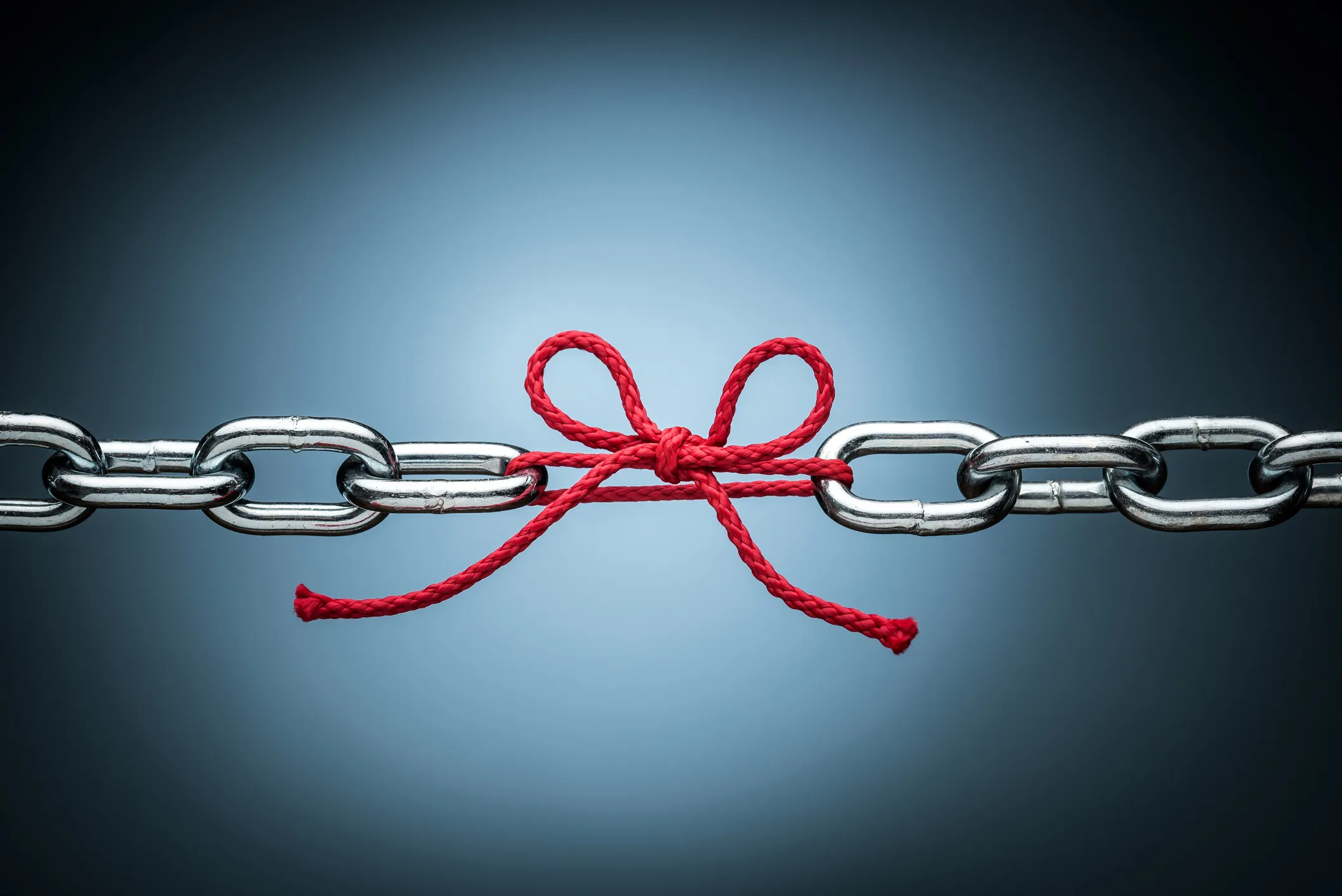 A Red ribbon connect two chain links to represent the role of link analysis in investigations.